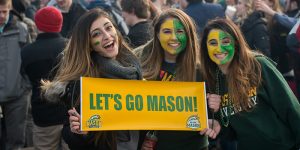 photo of 3 young women with facepaint in green and gold from Homecoming 2015