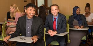 photo of two undergraduate students in suits