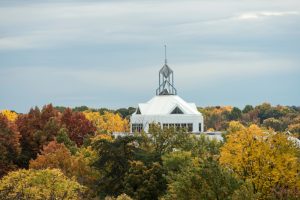 photo of the JC emerging from fall trees