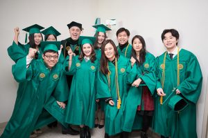 Mason Korea students in caps and gowns with President Angel Cabrera