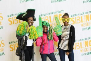 three black women and girls, of varying ages, dressed in mason gear against a white mason background