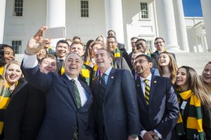 Gov. Ralph Northam and Virginia Secretary of Education Atif Qarni, pose with President Ángel Cabrera and Mason students on the Capitol steps during Mason Lobbies Day. Photo by Evan Cantwell.