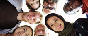 diverse group in a circle, photo taken from below at faces looking down