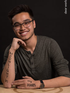 Erik Truong with the words "Moonlight in my Hands" written on his arms.