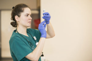 Nurse drawing an injection