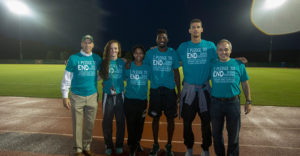 Athletic Director Brad Edwards, left, and President Ángel Cabrera, right, pose with students wearing pledge t-shirts, indicating that they took a pledge to end sexual violence, at the Men's Soccer game against the University of Virginia. The pledge was part of the Fear to Freedom program, in conjunction with the Freedom & Learning Forum. Photo by Craig Bisacre/Creative Services/George Mason University