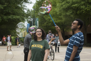 Two students blowing bubbles. Student life on the North Plaza. Photo by Evan Cantwell/Creative Services/George Mason University