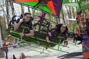 Two students on a carnival ride at Mason Day
