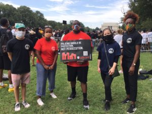 Members of Mason's John Mitchell, Jr. Program attended the 57th anniversary of the March on Washington on August 28, 2020. From left to right: Jordan Mrvos (Carter School MS graduate ‘20), Ajanet Rountree (Carter School PhD student), Charles L. Chavis, Jr. (Carter School assistant professor and JMJP founding director), Audrey Williams (Carter School MS student), Chinyere Erondu (Carter School MS student). Photo provided.
