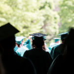 students at graduation in silhouette