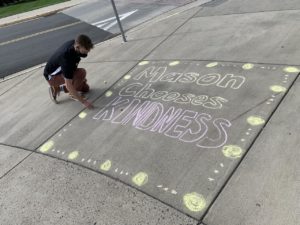 kindness messages written in chalk by students and the Mason Chooses Kindness banner outside the Johnson Center