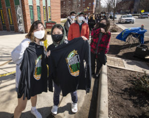 masked students with "brave and bold" sweatshirts at homecoming