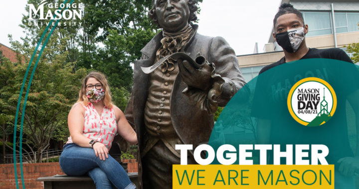 Two masked students around the George Mason statue