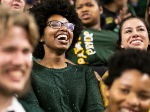 young black woman laughing in a crowd
