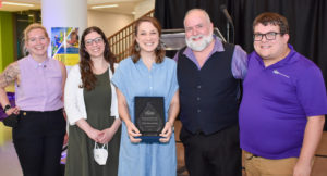 Holly Mason Badra (left in blue) receives the Rose Pascarell and Ric Chollar Professional Service Award for her work to advance LGBTQIA+ visibility