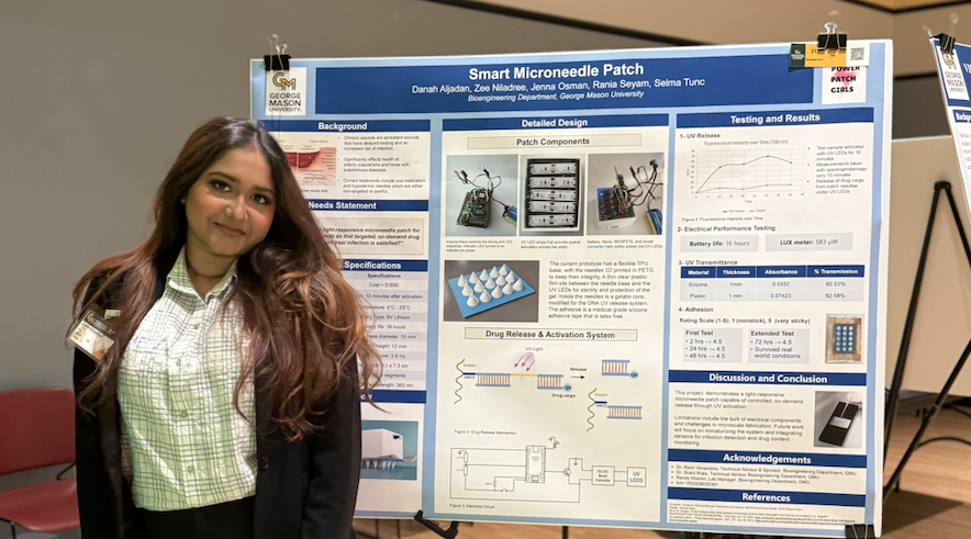 Zarin Musarrat Niladree stands smiling next to a research poster titled "Smart Microneedle Patch" at a university showcase. The poster, attributed to the Bioengineering Department at George Mason University, details the patch's design, drug release mechanism, and testing results.